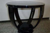 An elegant side table, four curved legs mounted on a round base